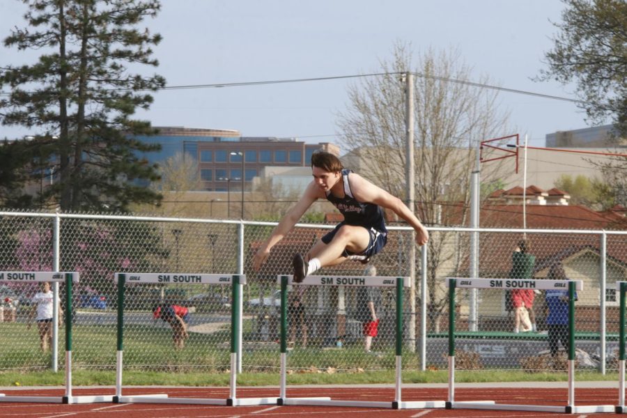 Junior Carter Kemp clears a set of hurdles in whilst competing in the 300 meter hurdle race. Kemp took 10th in the 300 meter hurdles with a final time of 47.27 seconds.