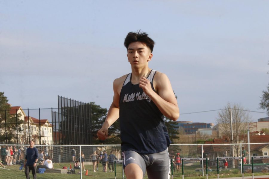 Running down the track, junior Dylan Nguyen eyes the next hurdle in the 300 meter hurdle race. Nguyen would go on to place sixth in the race running a time of 43.20 seconds.