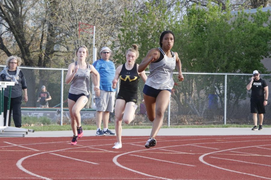 Leading freshman Addison Long, junior Savannah Harvey rounds the track in sprinting the 200 meter dash. Harvey finished in third place for the 200 meter dash with a time of 26.42 seconds tying the 12-year old school record.