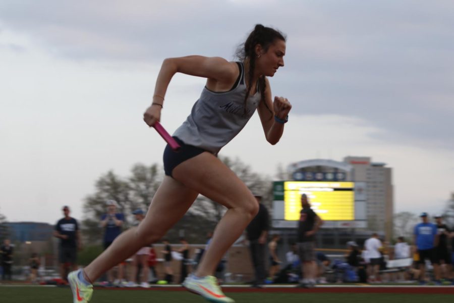 At the sound of the starting pistol, senior Quincy Hubert pushes off from her starting block to start the 4x400 meter relay.