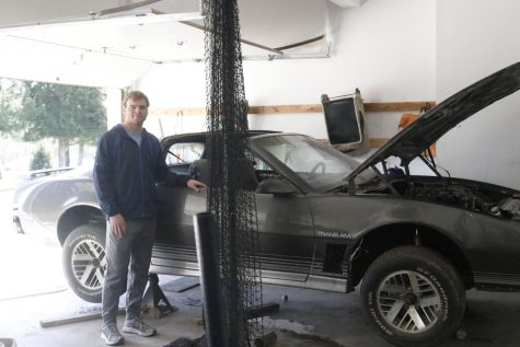 Standing next to his Trans Am, Saturday, April 9, senior Christian Ammann takes in his hours of hard work and dedication