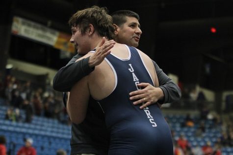 After winning the individual state title, former wrestler Ethan Kremer embraces Travis Keal. Kremer won the individual state title three times in his career wrestling with Keal.