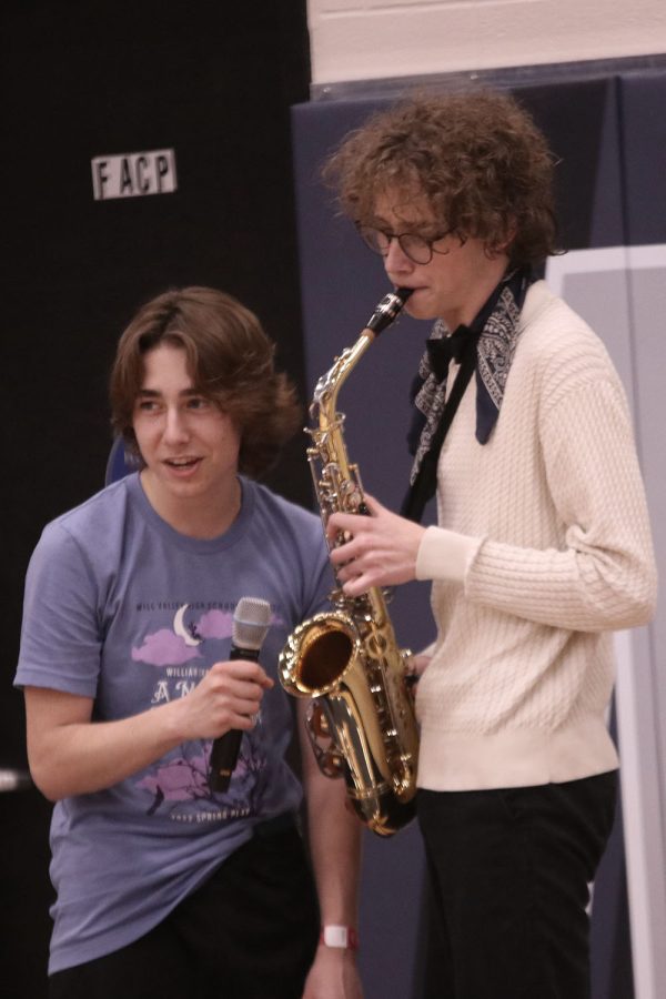 Playing the saxophone, junior Sean Olin performs at the open mic portion of Relay for Life.