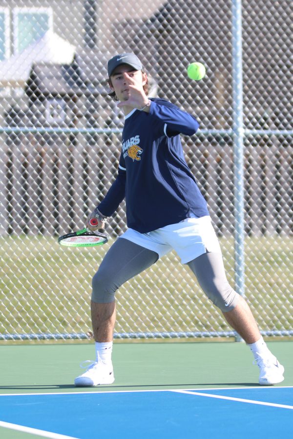 Preparing to hit, senior Gage Foltz secures another point in his match he won 8-0 Friday, April 1.

