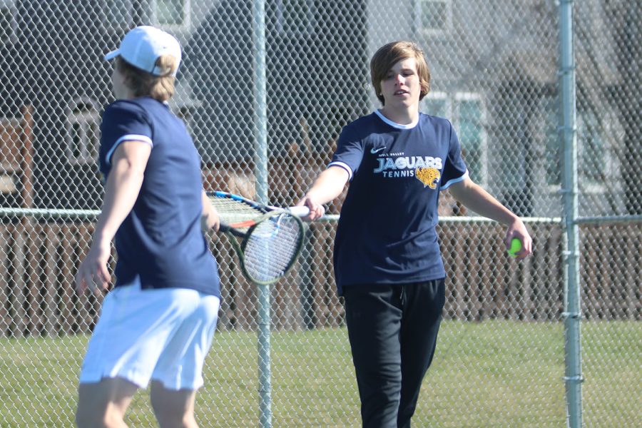 Hitting rackets, senior Derek Mulder congratulates his doubles partner, senior Ben Fitterer, on a job well done Friday, April 1.
