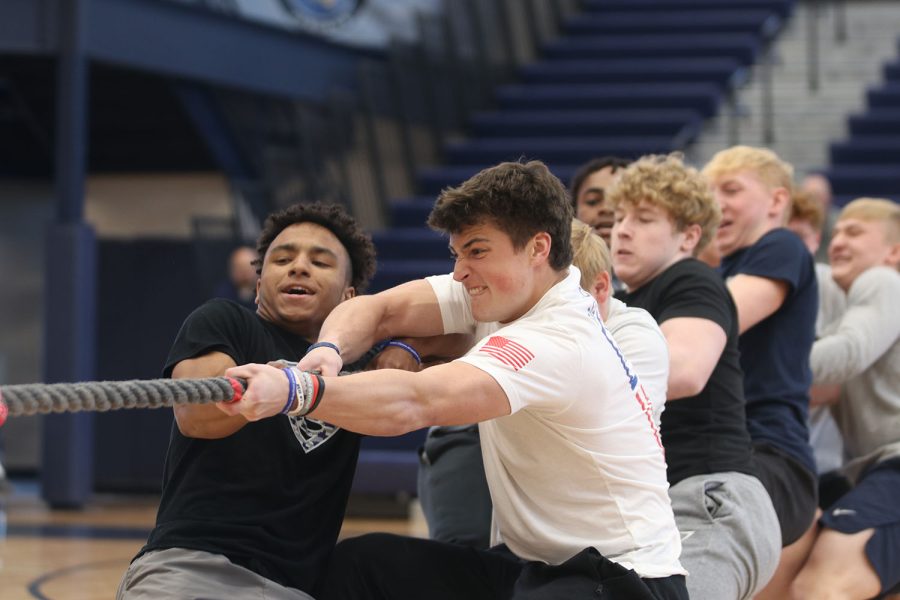 Pulling, juniors Mark Bauer and Sidney Lockhart focus on beating the sophomore class in the tug of war championship during the prom pep assembly Friday, April 1. 