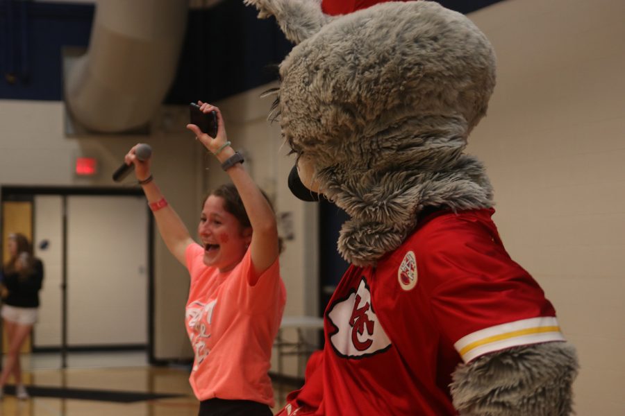 Arms up, senior Lauren Walker dances with KC Wolf Saturday, April 23 during the annual Mr. Relay contest.