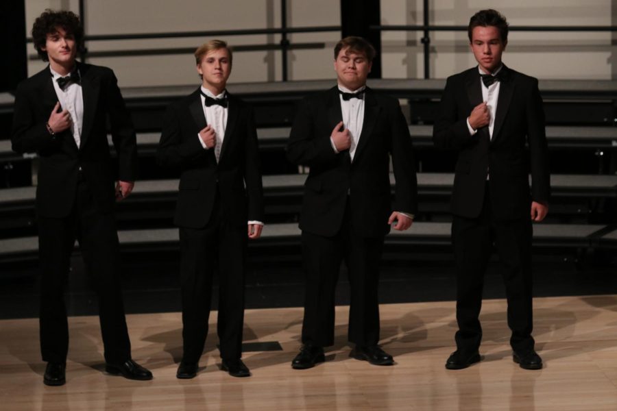 Juniors Brayden Heath, Carter Harvey, Luke O’Neal and sophomore AJ Lauer all stand in line at the spring concert Tuesday, March 29.