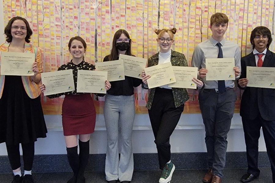 Voyagers members stand together with their Model UN certificates. 
