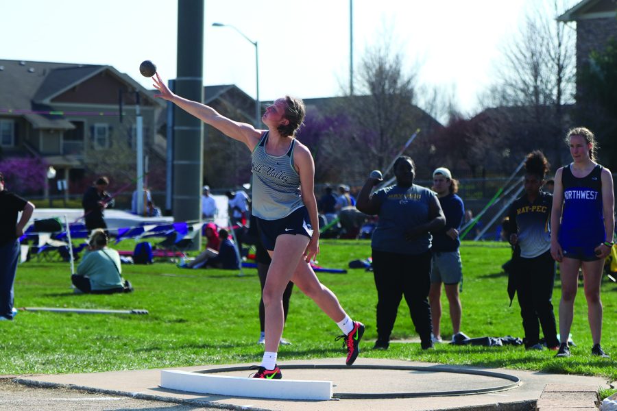 Senior Emree Zars releases the shot put from her hand.