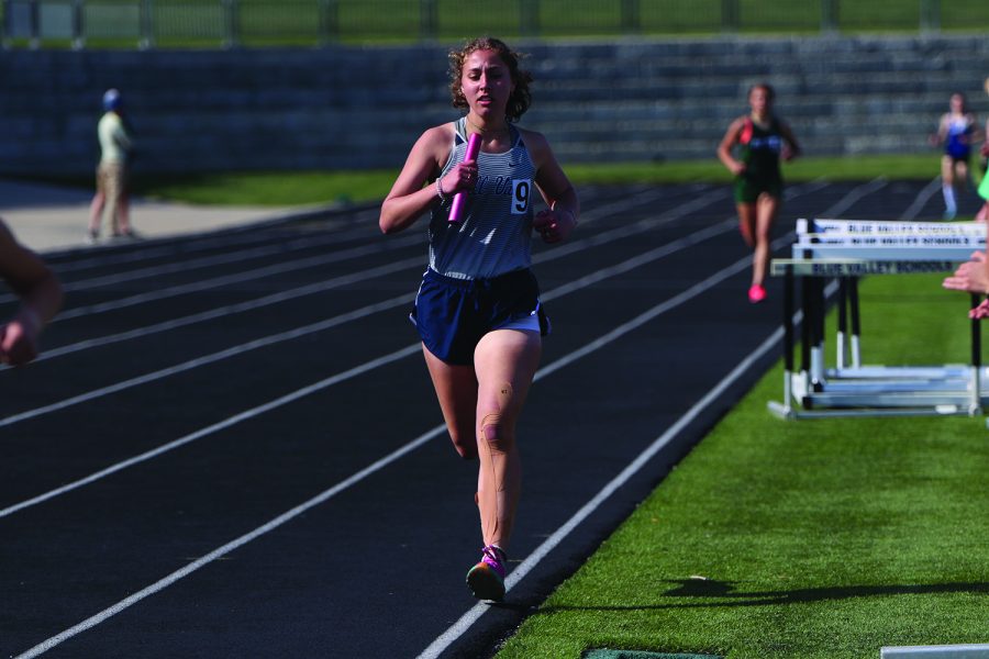 Baton in hand, sophomore Sarah Anderson competes in her leg of the race. 
