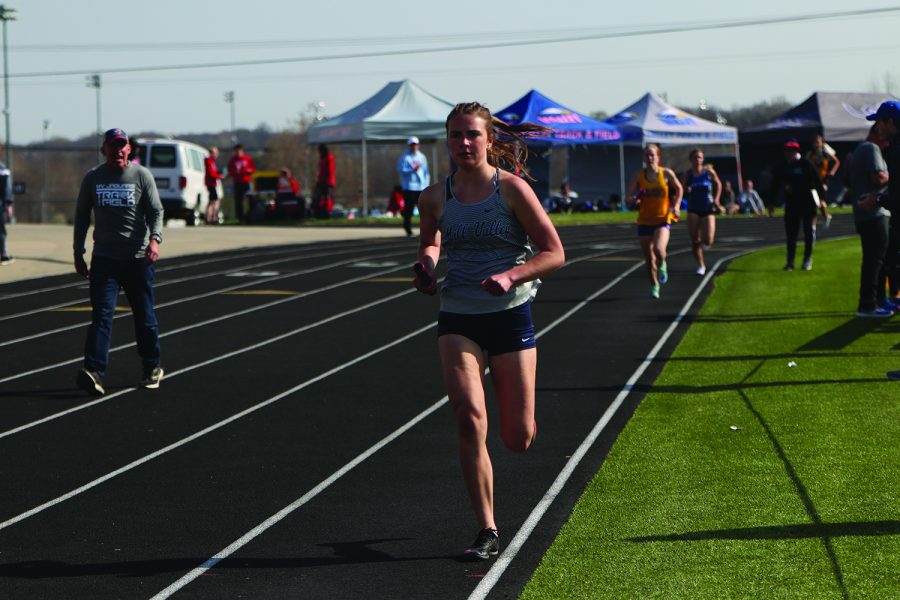 Ahead of the competition, senior Logan Pfeister runs on the track. 