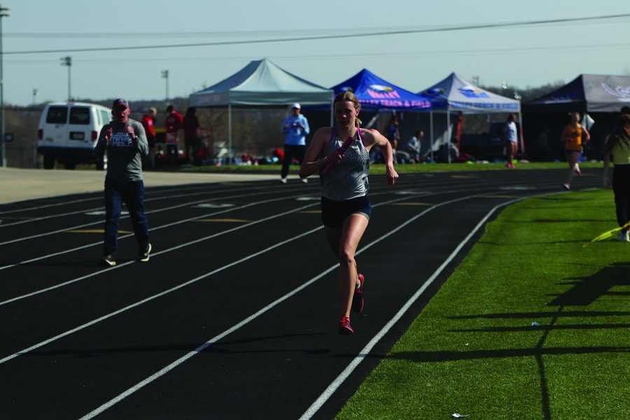 Giving her all, senior Katie Schwartzkopf competes in her leg of the relay. 
