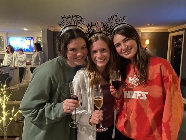 Glasses in hand, Wootton, Schwartzkopf and Pfiester pose for a picture at a New Years Eve party. Schwartzkopf admires how she, Pfiester and Wootton each bring a different group dynamic to their friend group. 