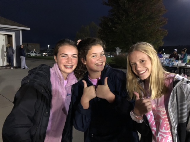 Decked out in pink to participate in the annual Pink Out theme at one of Mill Valleys home football games,  Pfiester, Schwartzkopf and Wootton pose for a picture.