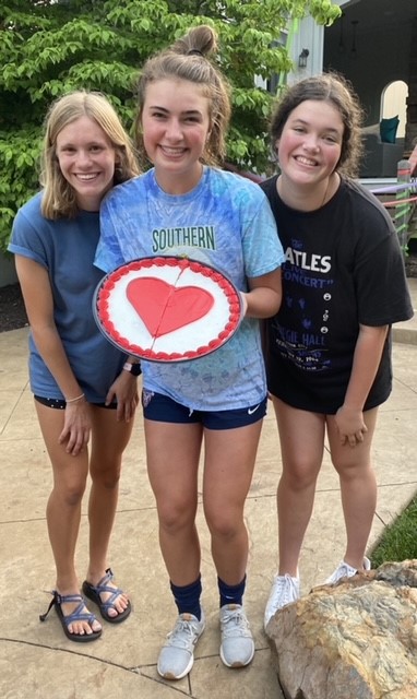 Schwartzkopf, Pfiester and Wootton celebrate one year since Pfiester received open heart surgery with a heart cookie cake on July 2, 2020.