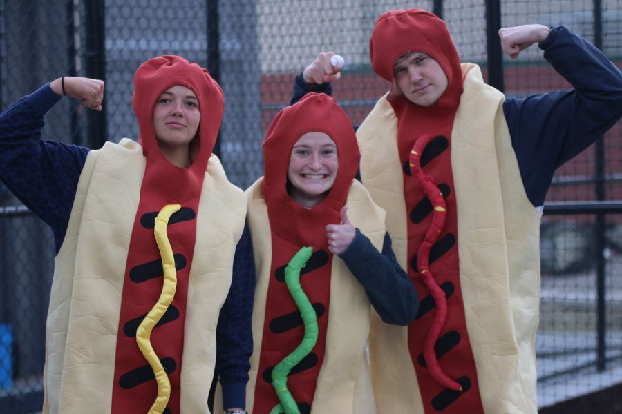 Seniors Maggie Smith, Lauren Walker and Bret Weber pose before a hotdog race that took place after the first inning of the softball game. 