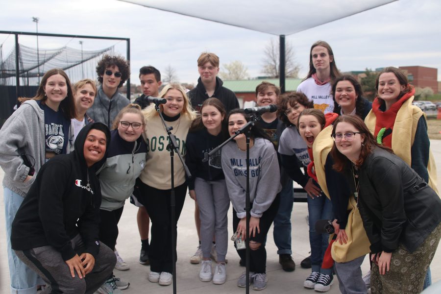 Choir students pose together before they sing the National Anthem before both the softball and baseball games begin. 