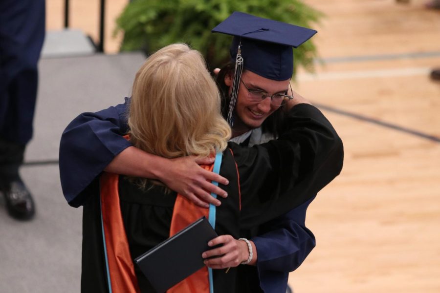 Senior Brandon Mays hugs principal Dr. Gail Holder. 