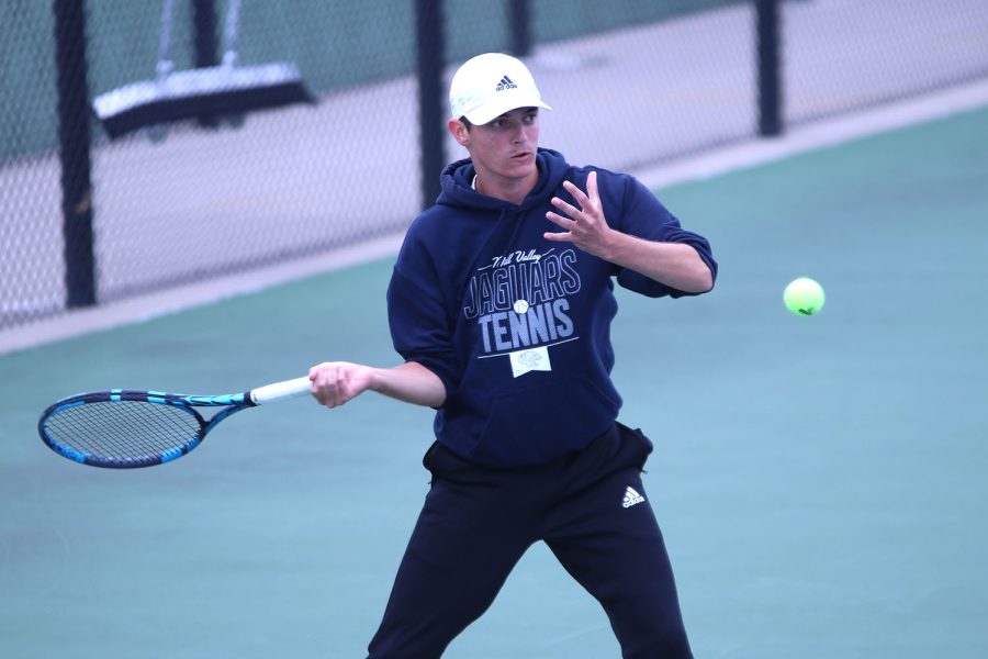 Receiving the ball, senior Luke Hansen gets ready to hit it back to his opponents side. 