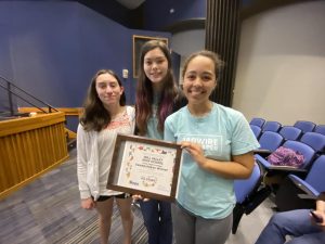 Sophomore Julia Schumaker and juniors Avery Gathright and Gabby Delpleash accept the state title plaque at the KSPA journalism contest Saturday, May 7 at KU.