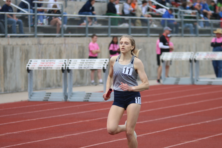 Running the first leg of the 4x800 meter relay, senior Bridget Roy completes her first lap of the race.