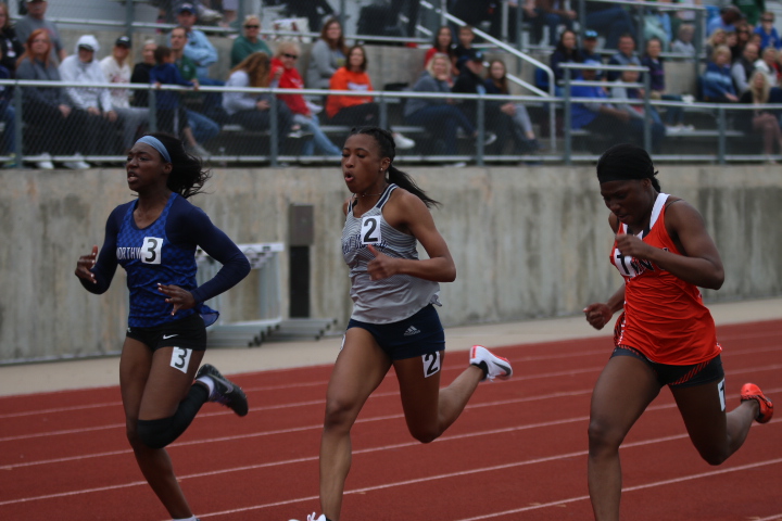 Neck and neck with two other sprinters, junior Savannah Harvey pumps her arms to gain a lead in the 100 meter sprint. Harvey finished the sprint in fifth place with a time of 12.70 seconds. Harvey is currently ranked in the state top 50 for her sprint performance.