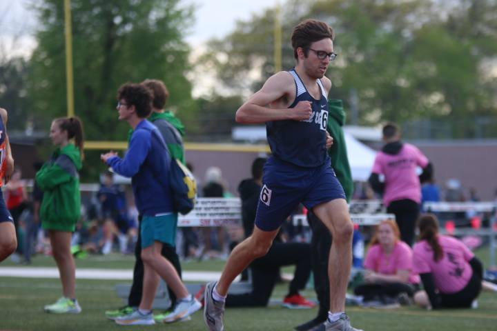 Senior Nic Botkin pumps his arms to gain momentum for the last 200 meters of the 1600 meter race. Botkin took 12th in the race with a time of 4:23 seconds.