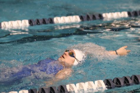 Counting her backward strokes, junior Torri Olivarez reaches backwards Friday, May 6 at the Shawnee Mission Aquatic Center.