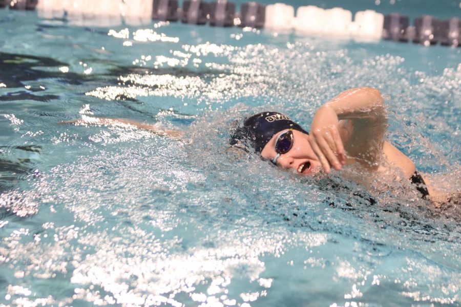 Reaching forward, junior Suzette Donovan races forward in with freestyle stroke Friday, May 6 at the Shawnee Mission Aquatic Center.