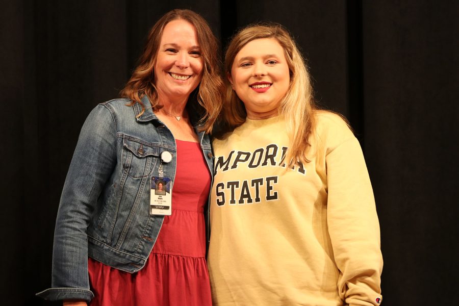 After signing to Emporia State for color guard, senior Anna Springer stands with councilor Erin Hays. 