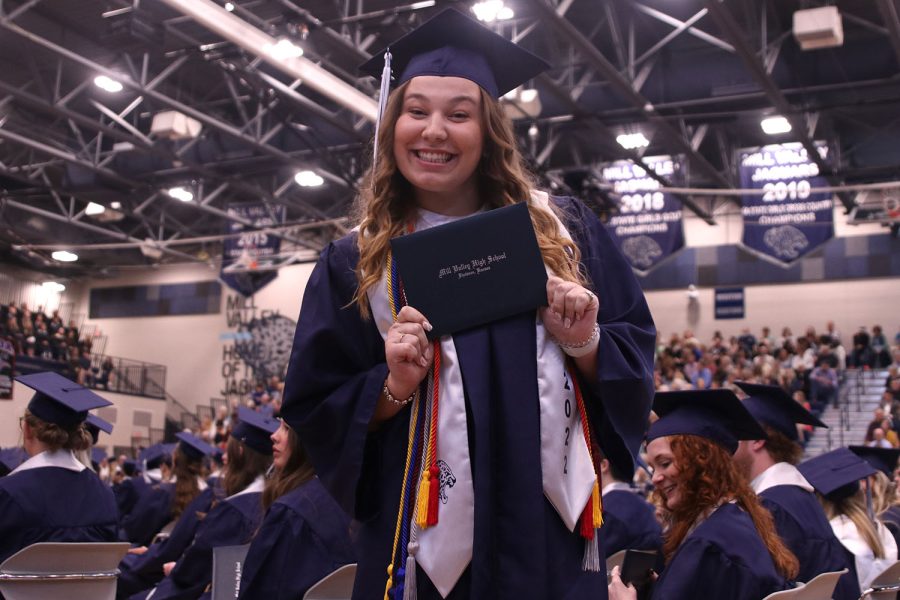 On the way back to her seat, senior Allison Seck poses with her diploma. 