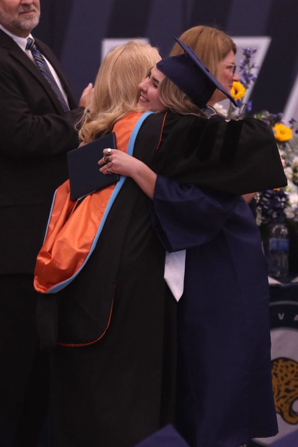 With a smile on her face, senior Elise Canning hugs principal Dr. Gail Holder. 