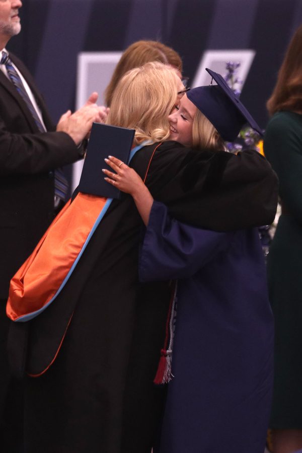 Senior Avery Davis hugs principal Dr. Gail Holder. 