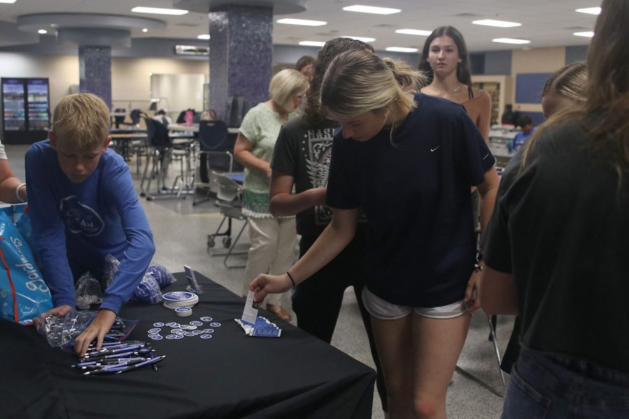 In the commons, Jag Pride member senior Natalie Merley help the Davis family set up their informational table.  
