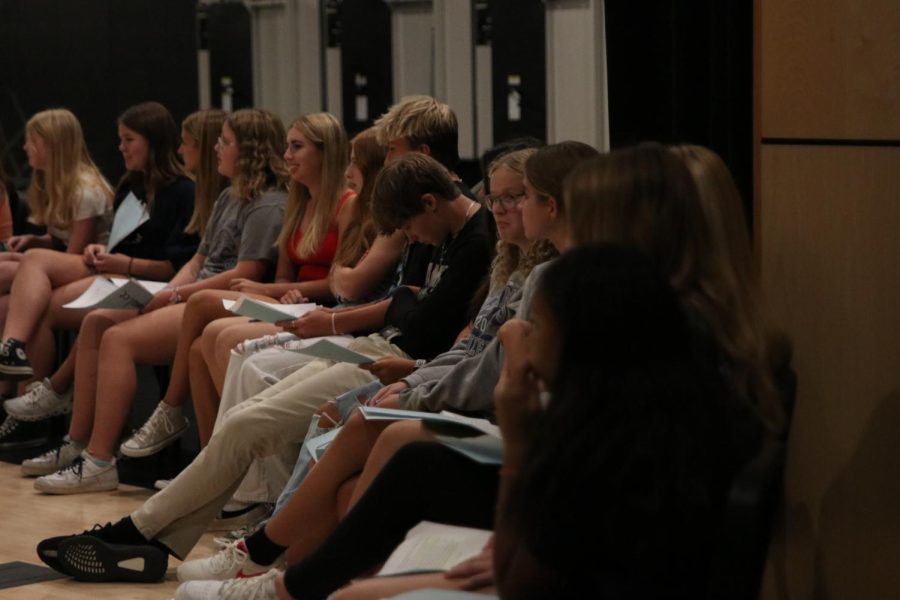 While waiting for the next candidate to deliver their speech, freshman StuCo candidates sit amongst each other on stage Friday, Aug. 26.