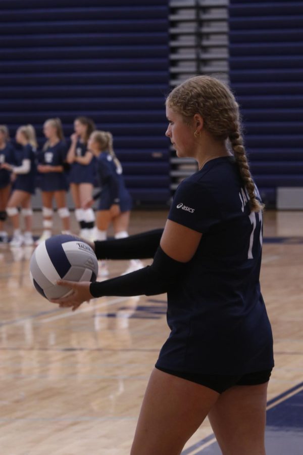 Freshman Abby Haney gets ready to serve the ball in. 