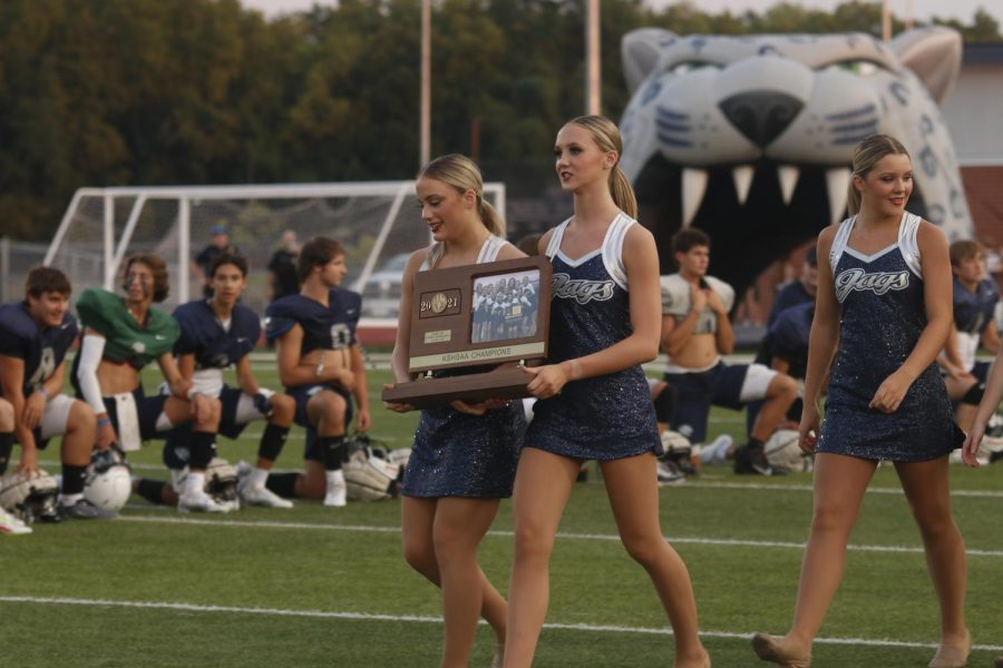 Holding the state trophy for the sliver star team are juniors Trinity Baker and Alli Gervais. 