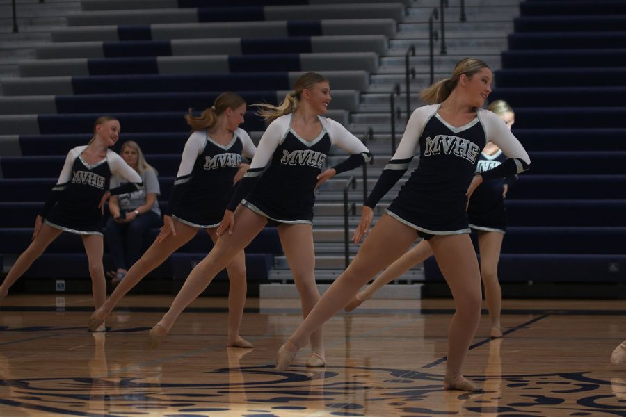 Leaning on one leg, the Silver Stars perform during the pep assembly.