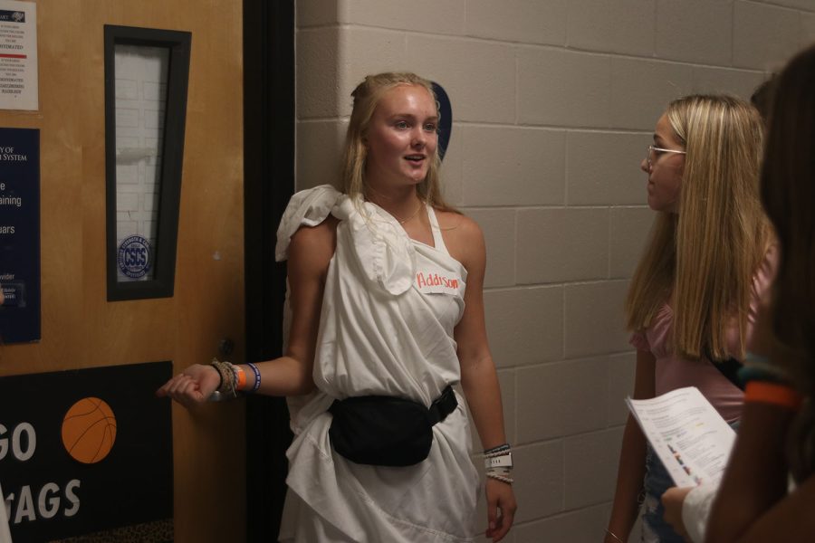 While giving a tour, junior Addison Bailey stops to show students a classroom. 