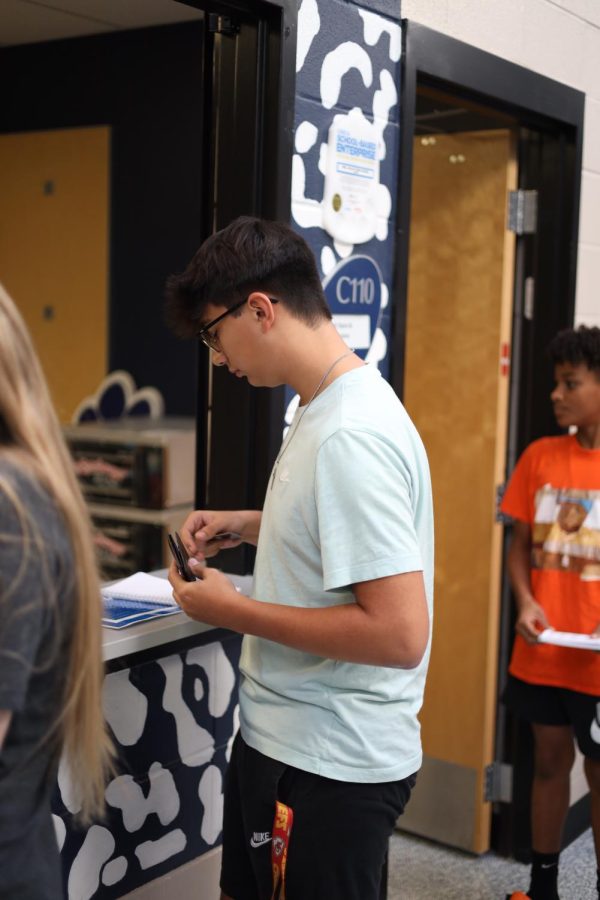 Junior Jude Middleton prepares to pay for his chips, Monday September 19.