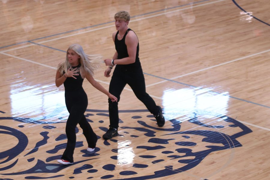 With hand on her chest, senior Homecoming candidate Brianna Coup struts away from senior Homecoming candidate Hayden Jay.