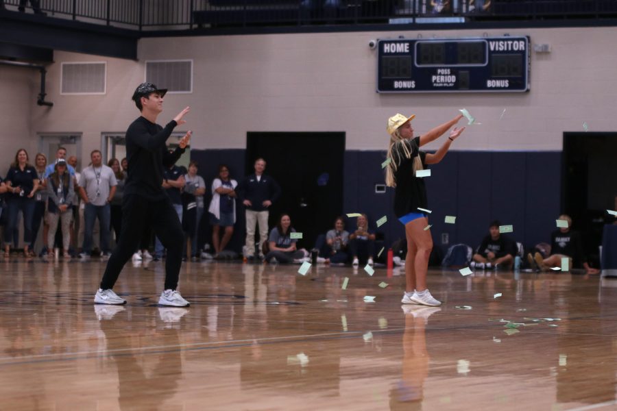 Throwing money, senior homecoming candidates Lucas Robins and Sophie Pringle perform a dance to Price Tag.