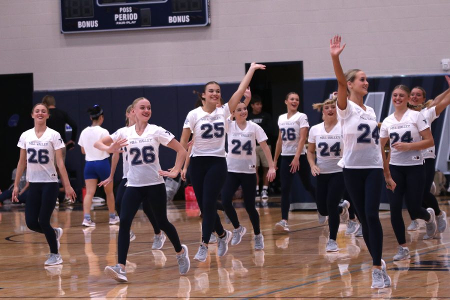 Smiling, the Silver Stars make their way to the center of the gym floor to perform their routine.