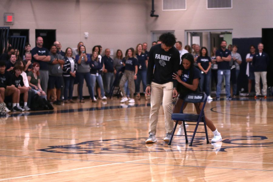 Shoving sophomore Jayden Woods, senior Savannah Harvey attempts to win the game of musical chairs.