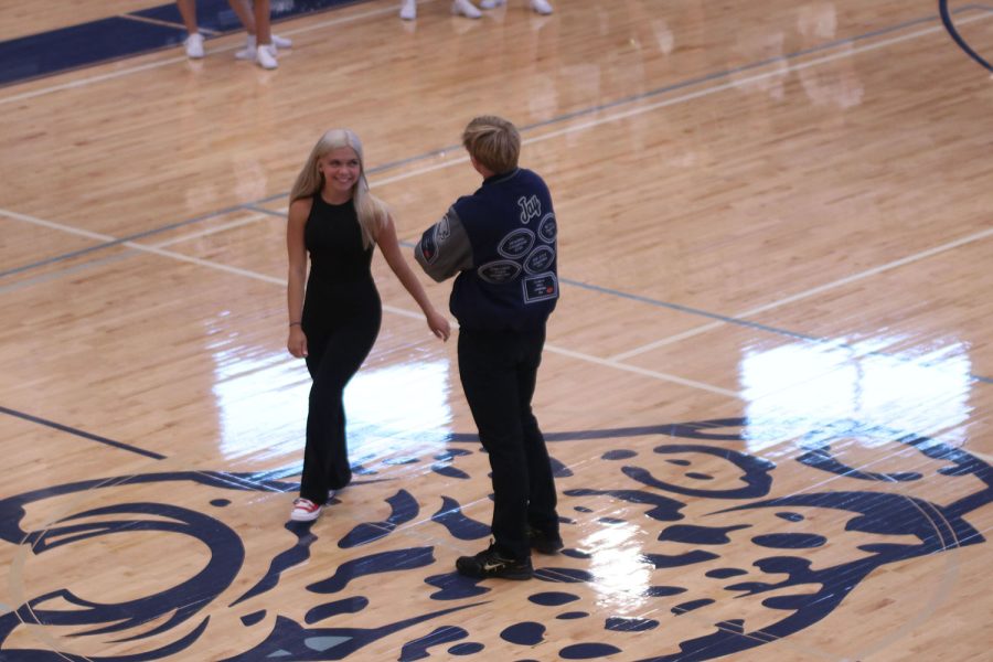 While practicing their performance for the pep assembly, senior Homecoming candidate Brianna Coup circles senior Homecoming candidate Hayden Jay.
