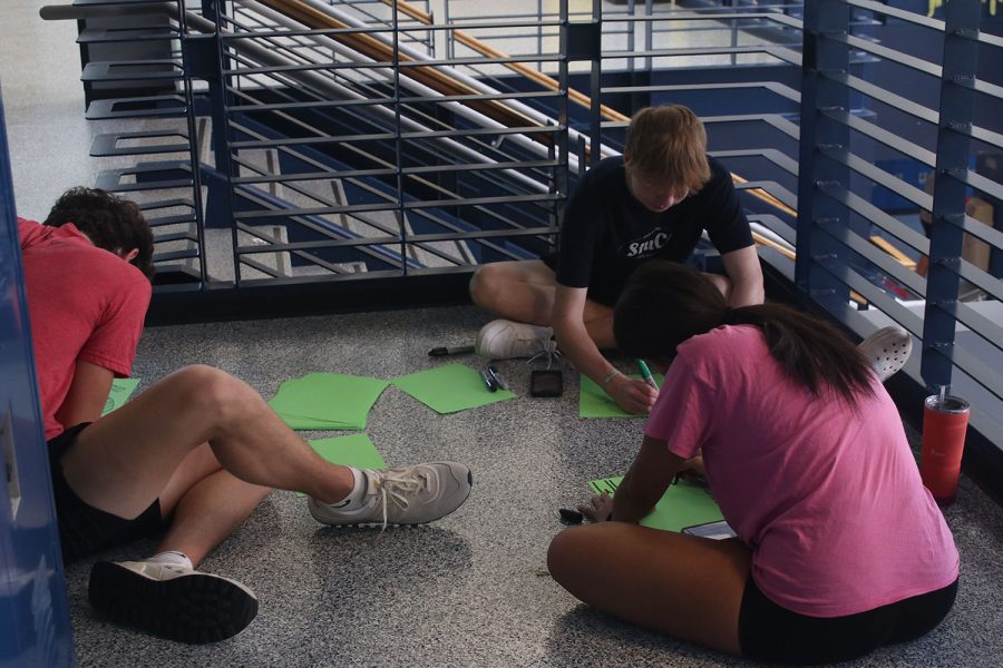 Getting ready for Homecoming week, sophomores Connor Bohon, Kenzie Johnson and Logan Koester decorate posters for the sophomore locker bank. 