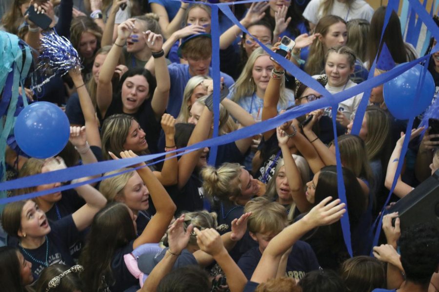Yelling the words to the songs, a group of senior girls stand in the mosh pit together.
