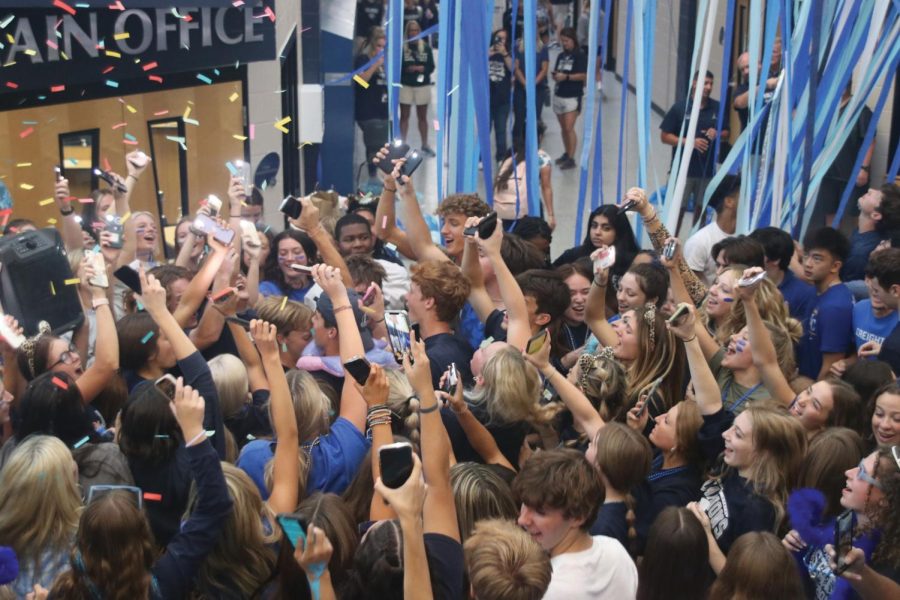 Holding their flashlights, seniors yell the words to the songs during Blue Bomb.