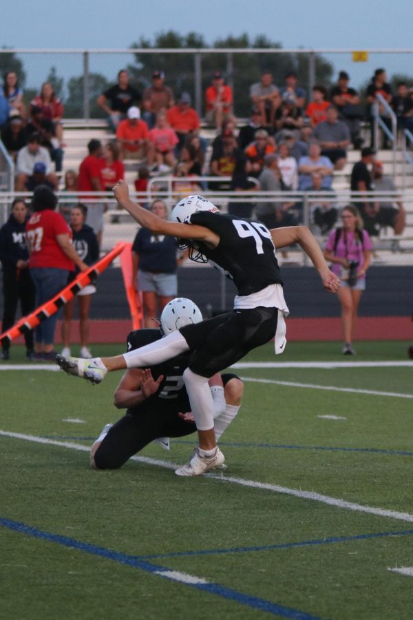After a touchdown was scored, junior Kenton Laughman kicks for the extra point.